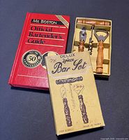 Overview showing guidebook, boxed bar tool set, outer Delux sleeve