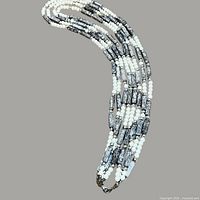 Full view of five-strand silver-tone and white bead necklace coiled