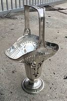 Full view of metal spittoon with handle and pedestal base