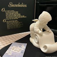 Front view of figurine with original box and booklet visible