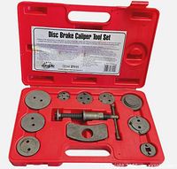Full view of caliper tool set in red case showing adapters, screw tool, reaction plate and T-handle