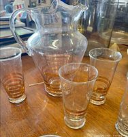Pitcher with three of the glasses grouped on table