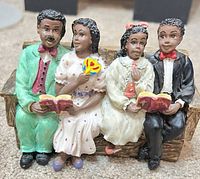 Full view of multicolor resin family figurine on pew