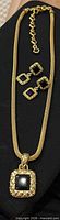 Full view of necklace with pendant and both earrings displayed