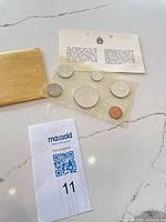 Full view of sealed 6-coin set, info card, and envelope