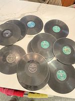 Group of 16 loose 78 rpm records spread on countertop