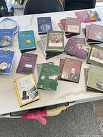 Group shot of assorted Great Courses DVD and guidebook sets spread on table