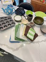 Full lot: teapot, muffin pans, dinnerware, towels