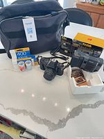 Group shot of bag, both cameras, film pack and Kodak box