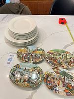 Stack of off-white plates and four Italian side plates