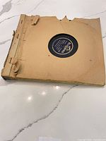 Album binder with visible damage and records inside