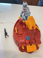 Side view of red/orange Roversled with pilot seated