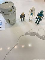 Escape pod and three action figures grouped