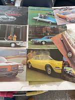 Nine posters laid out showing various GM car images
