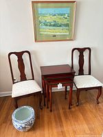 Full view of chairs, nesting tables, planter and framed print
