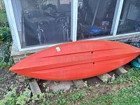 Full underside of kayak showing hull shape and scuffs
