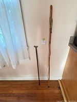 Full view of both canes leaning against wall