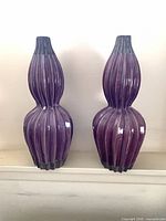 Front view showing both matching purple ribbed vases