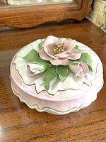 Top view showing applied flower and leaves on scalloped lid