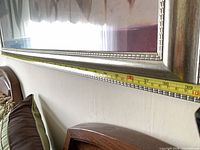 Side view showing frame profile and tape measure for length verification