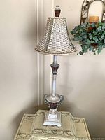 Full view of lamp on table showing shade, body and base