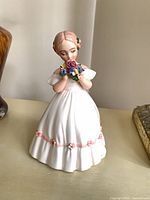 Front view showing figurine design and bouquet