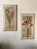 Both framed floral pictures hanging on wall