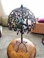 full view of metal tree candle holder on stool