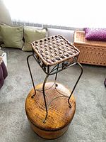 Full view of accent table showing woven top and metal frame