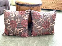 Front view of both pillows showing floral appliqué design
