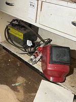 Mastercraft welder, face shield, welding rod boxes on shelf