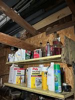 Overall view of two shelves with assorted chemical products and containers
