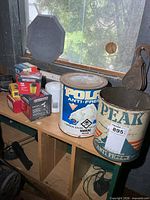 Shelf with Polar and Peak 1-gallon metal antifreeze cans, boxed oil filters