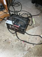 Front and top view of Motomaster battery charger with attached cables