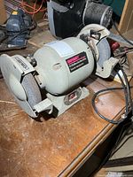 Full view of ShopCraft bench grinder on workbench