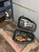 Chainsaw inside open black plastic case