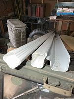 Three long white PVC pieces for gutter system