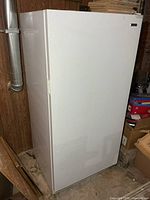 Front view of white Kenmore upright freezer