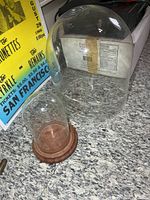 Overview of both glass domes, large and small with wood base