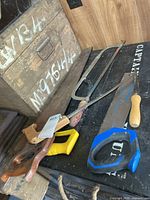 Overview of all saws laid out on black surface