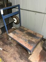Full view of blue steel cart on shed floor