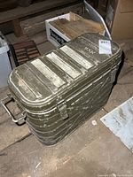 Full view of olive drab aluminum military cooler with lid closed
