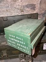 Crate top and front showing green paint and stencil text