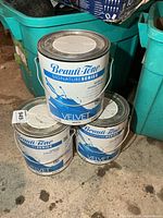 Three stacked Beauti-Tone Signature Series Velvet paint cans