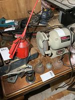 Overall view showing red pump oiler and three cone oilers on workbench