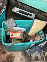 Tote with assorted plumbing and HVAC parts visible