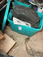 Tote top view showing large oval perforated basket and partial contents