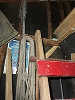 Ropes, chain and strap hanging on wall