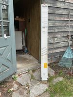 Full view of boxed Arrow floor frame kit leaning against shed wall