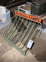 Front view showing orange Westinghouse Lamps sign, wire structure and size tag